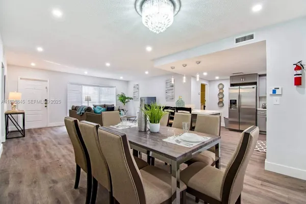 a view of a house with pool and chairs