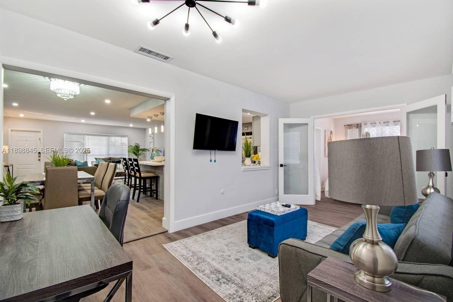 1305 Funston Street Hollywood, FL 33019 - Photo 67 of 93 a living room with furniture and a flat screen tv