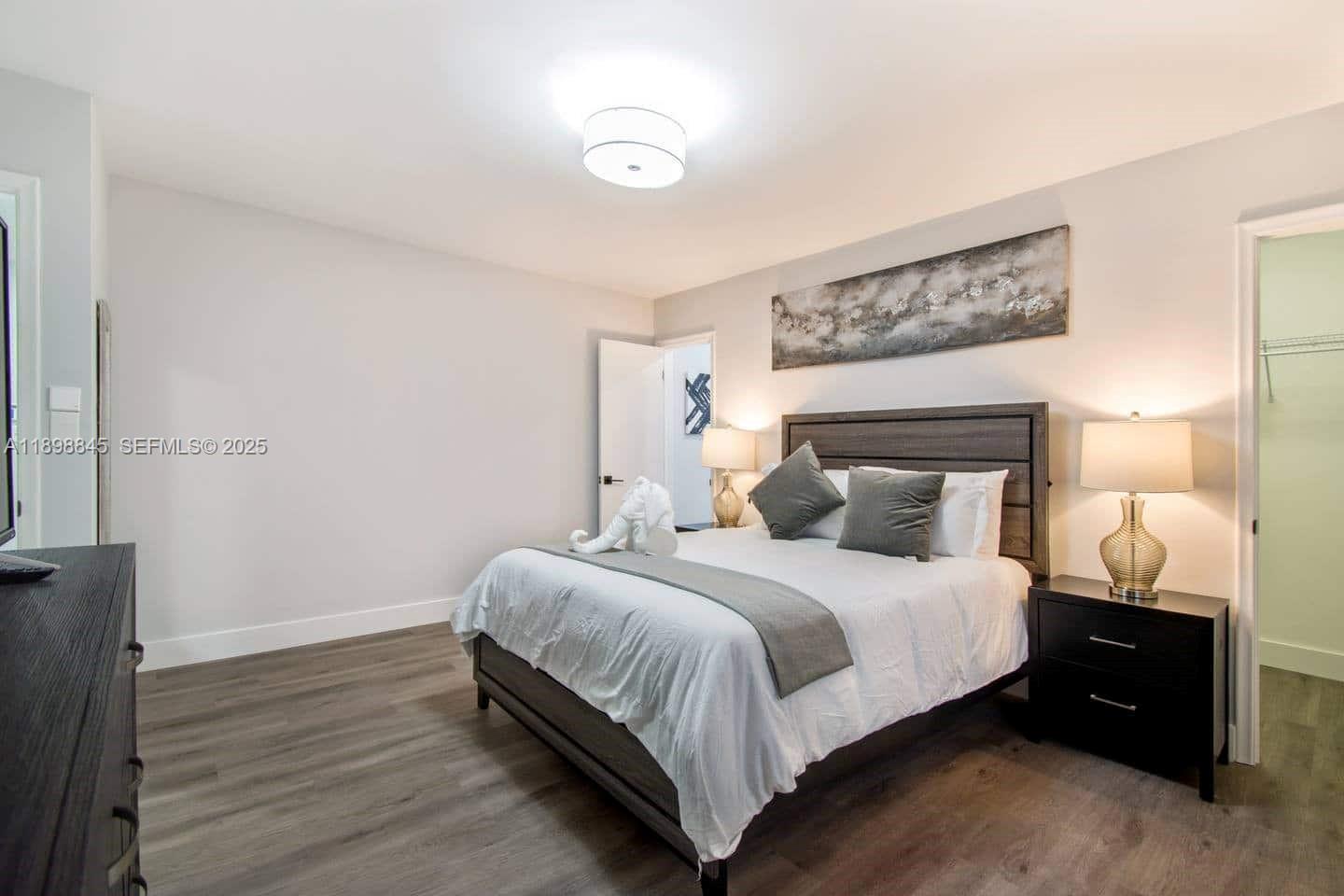 1305 Funston Street Hollywood, FL 33019 - Photo 70 of 93 a bedroom with a bed and a lamp