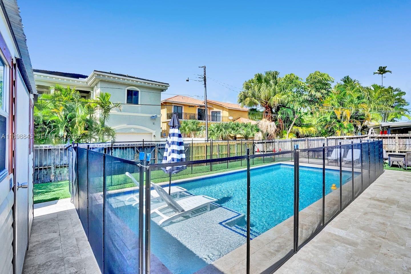 1305 Funston Street Hollywood, FL 33019 - Photo 74 of 93 a view of a backyard with wooden floor and iron fence