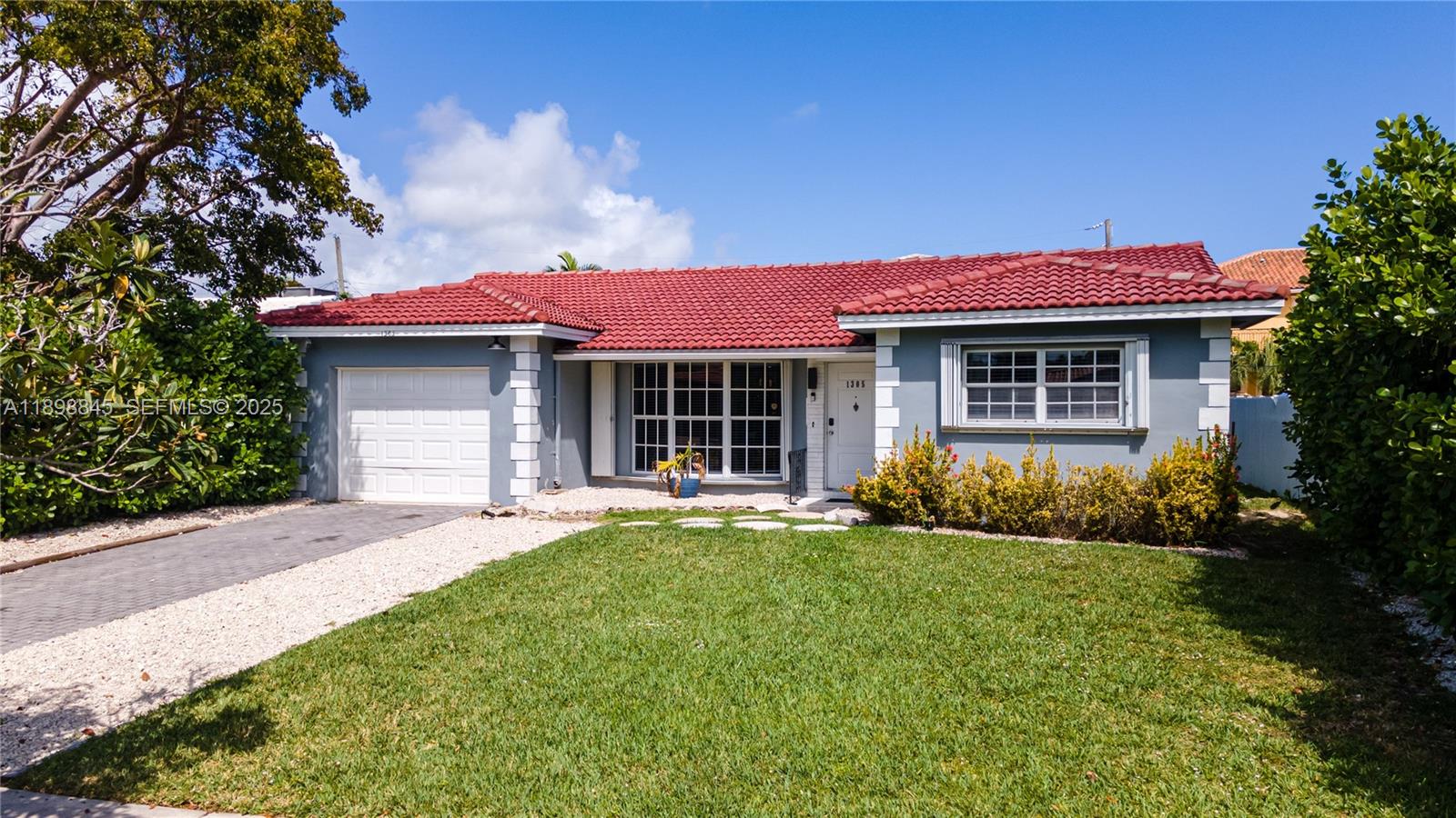 1305 Funston Street Hollywood, FL 33019 - Photo 77 of 93 a front view of a house with a yard and outdoor seating