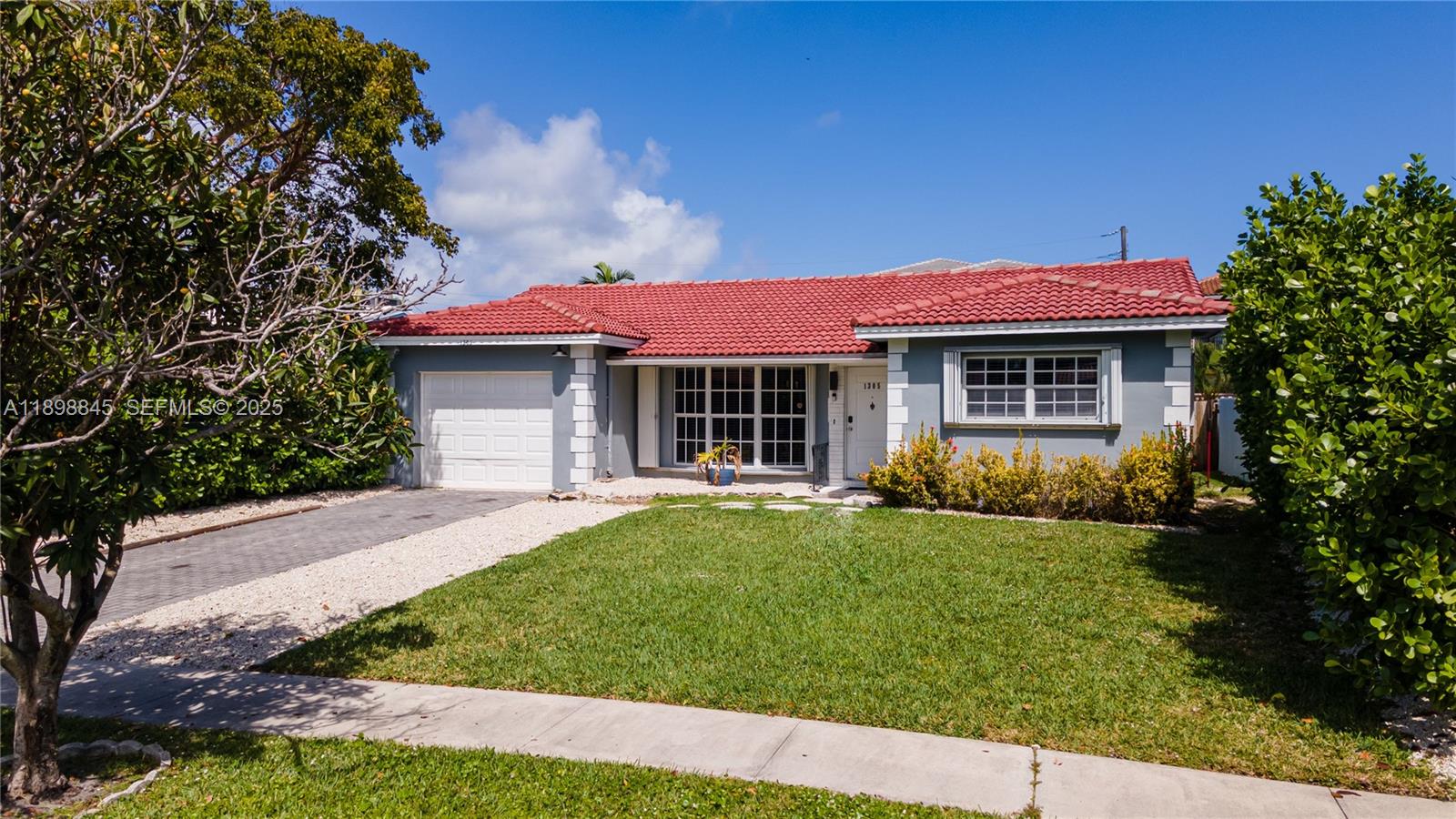 1305 Funston Street Hollywood, FL 33019 - Photo 78 of 93 a front view of a house with a garden