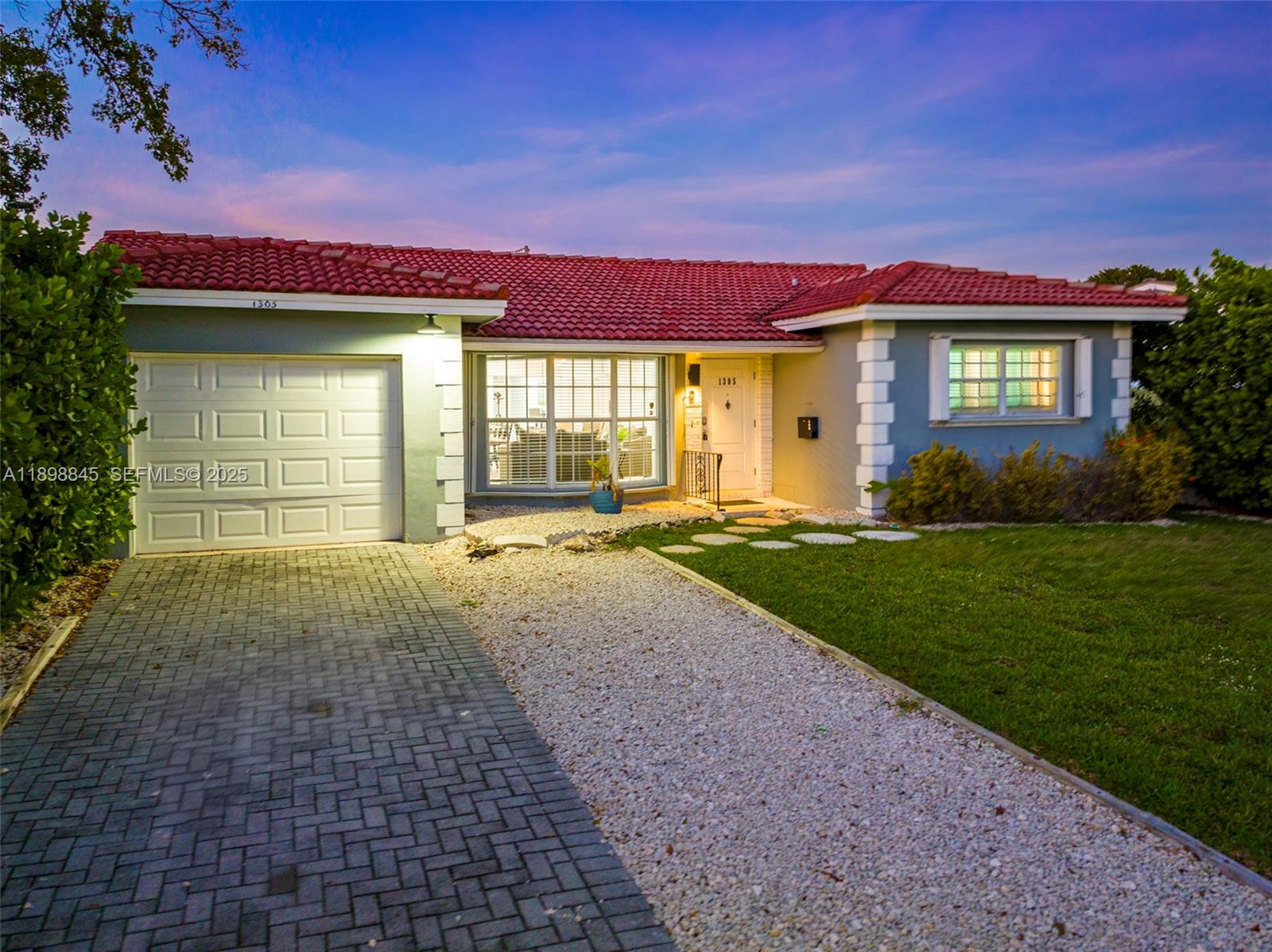 1305 Funston Street Hollywood, FL 33019 - Photo 90 of 93 a front view of a house with a yard and garage
