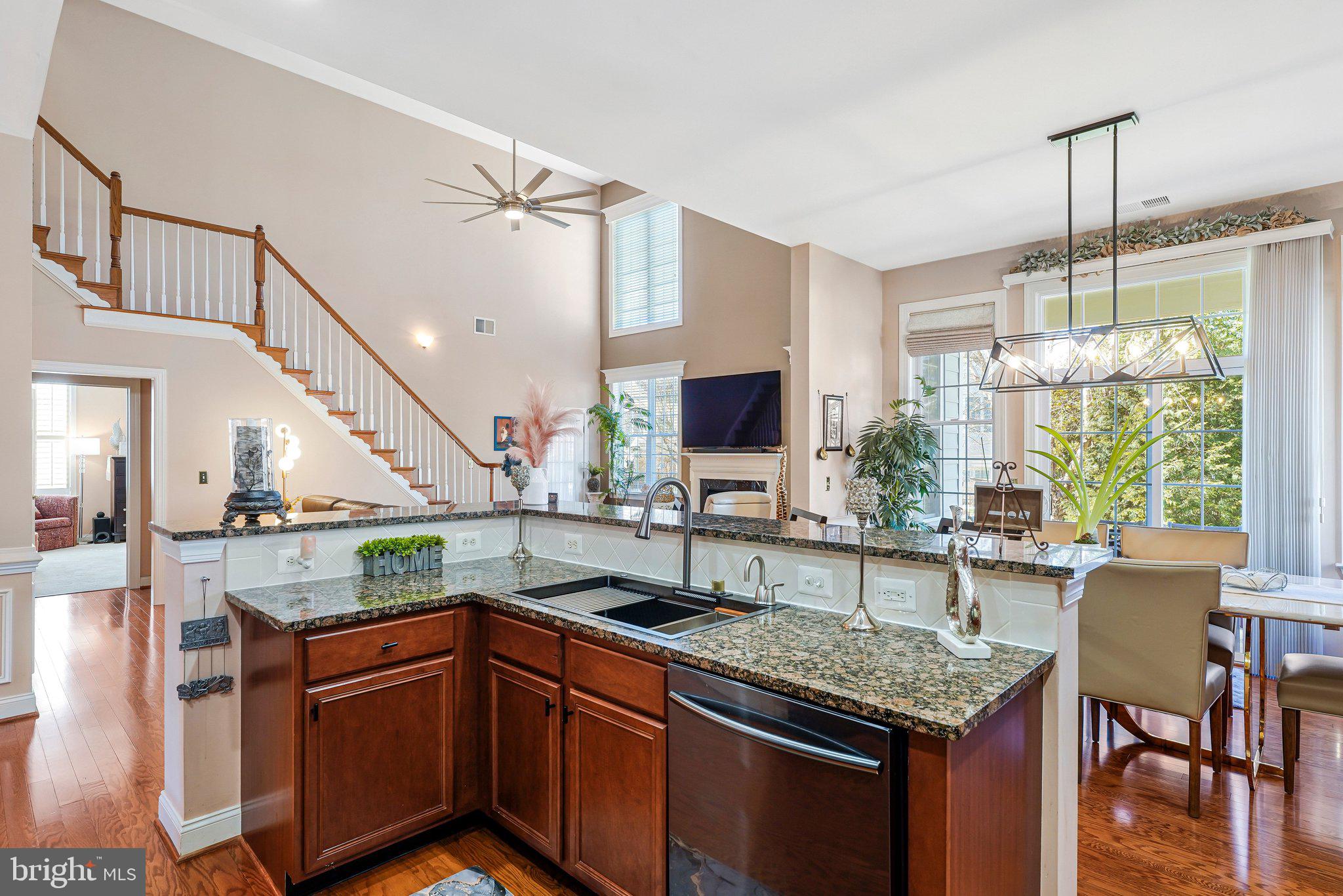 15517 Legacy Way Haymarket, VA 20169 - Photo 11 of 68 a kitchen with granite countertop a sink and a wooden floor