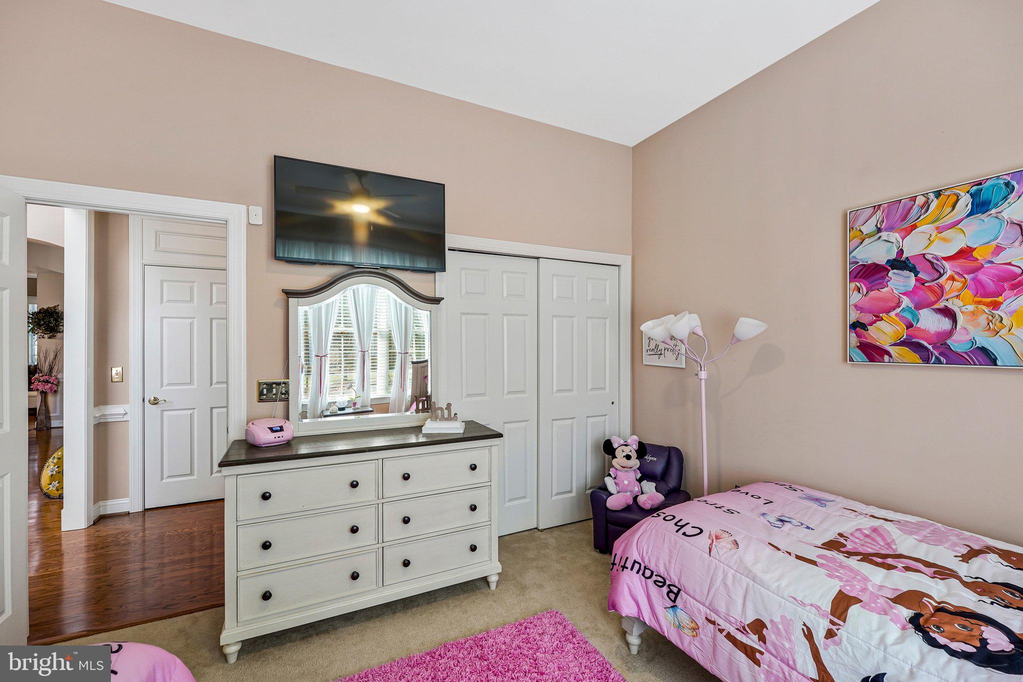 15517 Legacy Way Haymarket, VA 20169 - Photo 21 of 68 a bedroom with a bed table and a flat tv screen on dresser