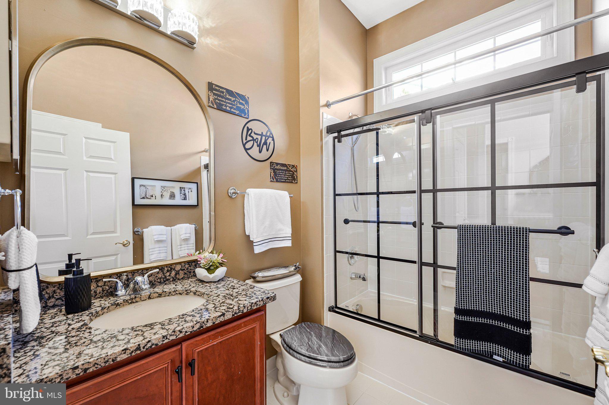 15517 Legacy Way Haymarket, VA 20169 - Photo 22 of 68 a bathroom with a granite countertop sink mirror vanity and toilet