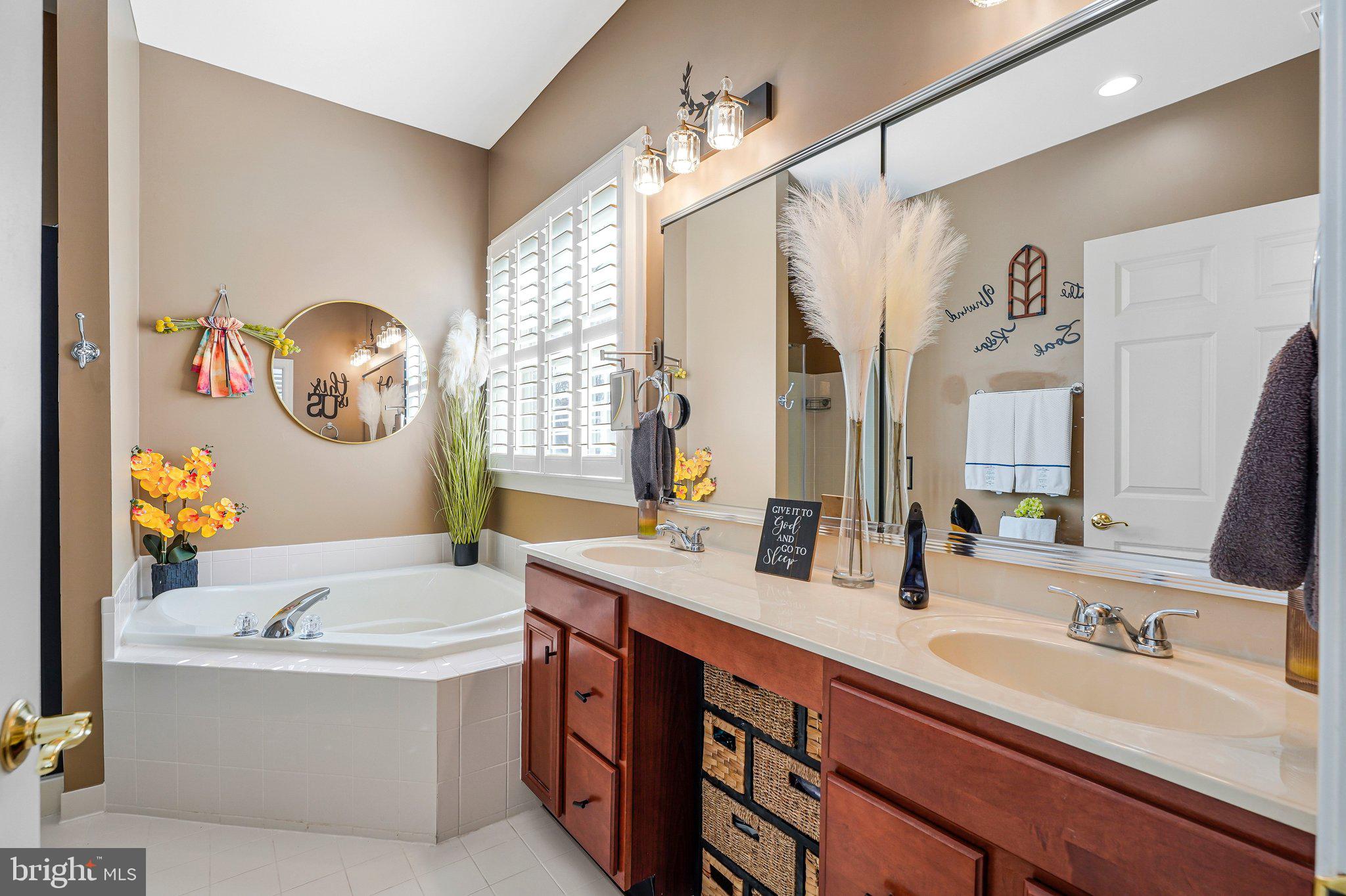 15517 Legacy Way Haymarket, VA 20169 - Photo 25 of 68 a bathroom with a tub sink and mirror