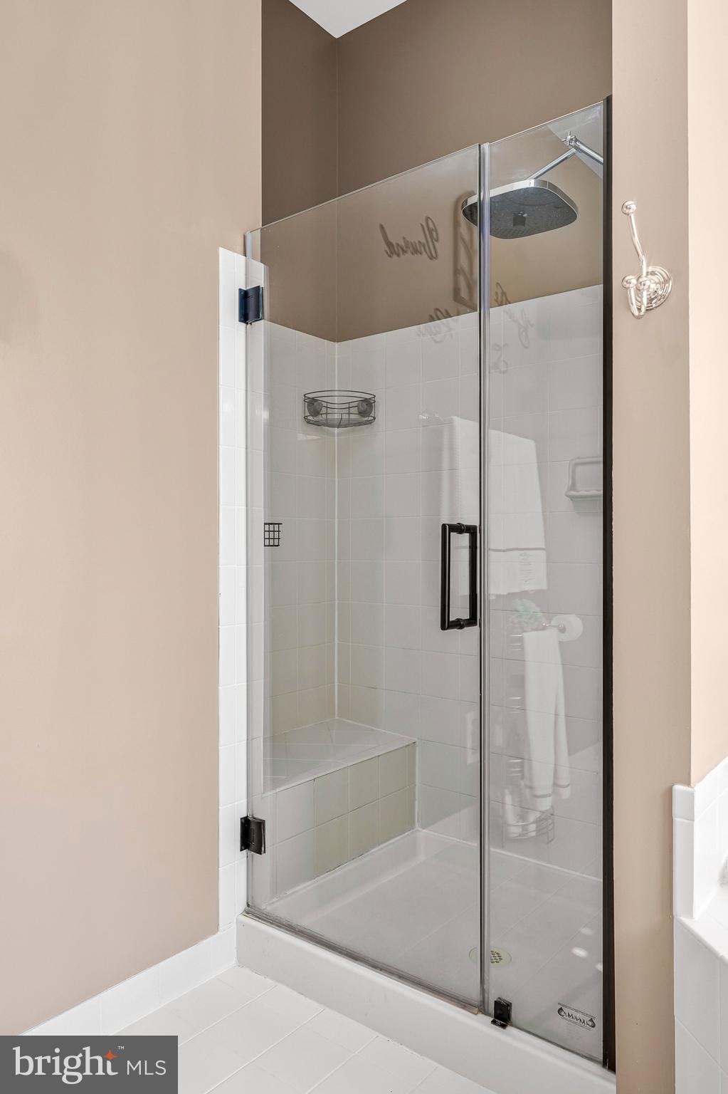 15517 Legacy Way Haymarket, VA 20169 - Photo 28 of 68 a bathroom with a glass shower door