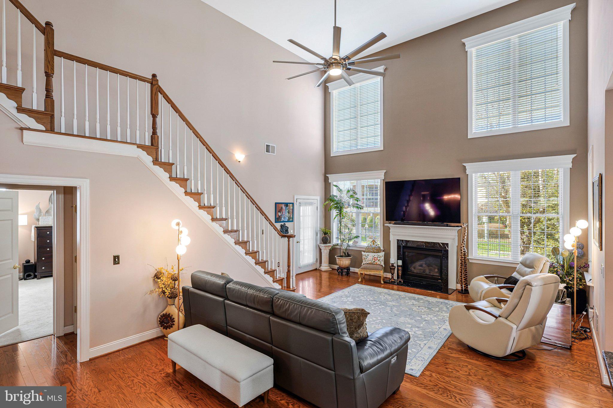 15517 Legacy Way Haymarket, VA 20169 - Photo 33 of 68 a living room with furniture a fireplace and a flat screen tv