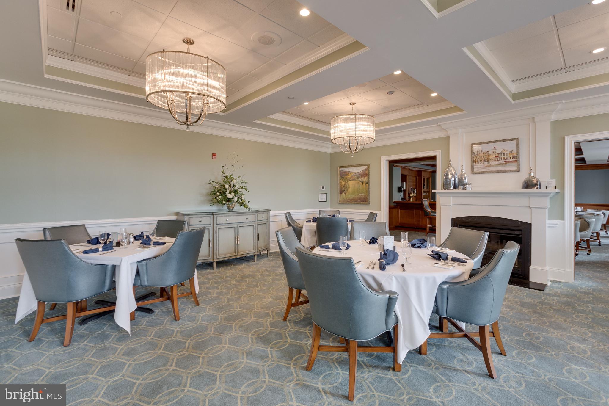 15517 Legacy Way Haymarket, VA 20169 - Photo 63 of 68 a dining room with furniture a chandelier and wooden floor