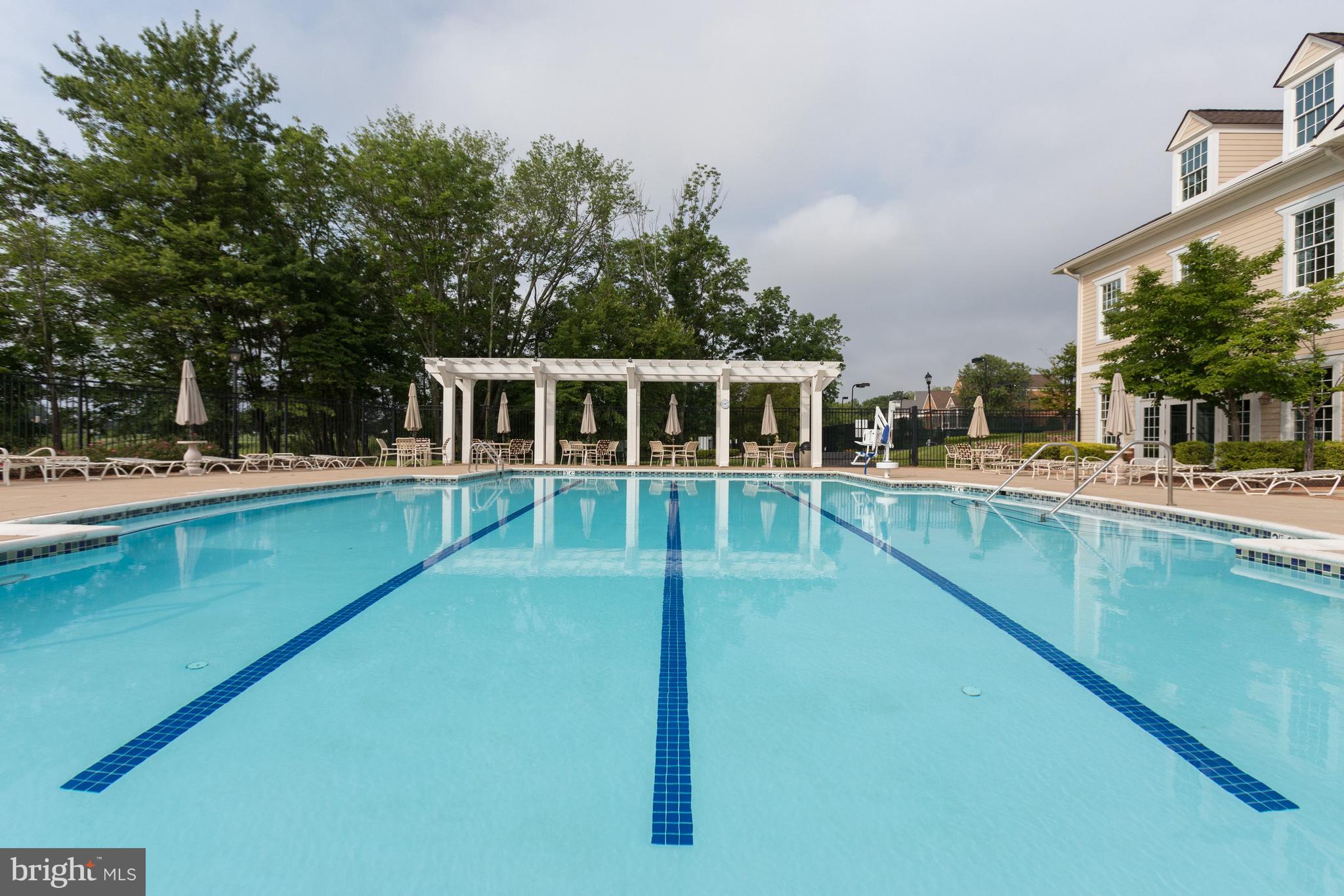 15517 Legacy Way Haymarket, VA 20169 - Photo 64 of 68 a view of a house with pool and trees in the background