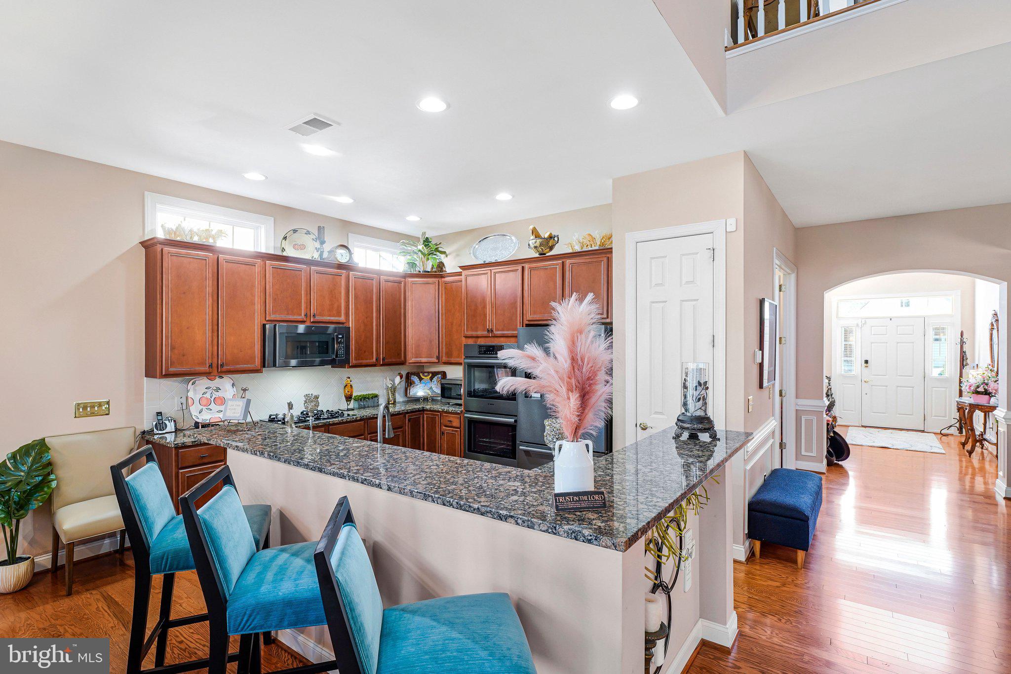 15517 Legacy Way Haymarket, VA 20169 - Photo 8 of 68 a kitchen with stainless steel appliances kitchen island granite countertop a sink and cabinets