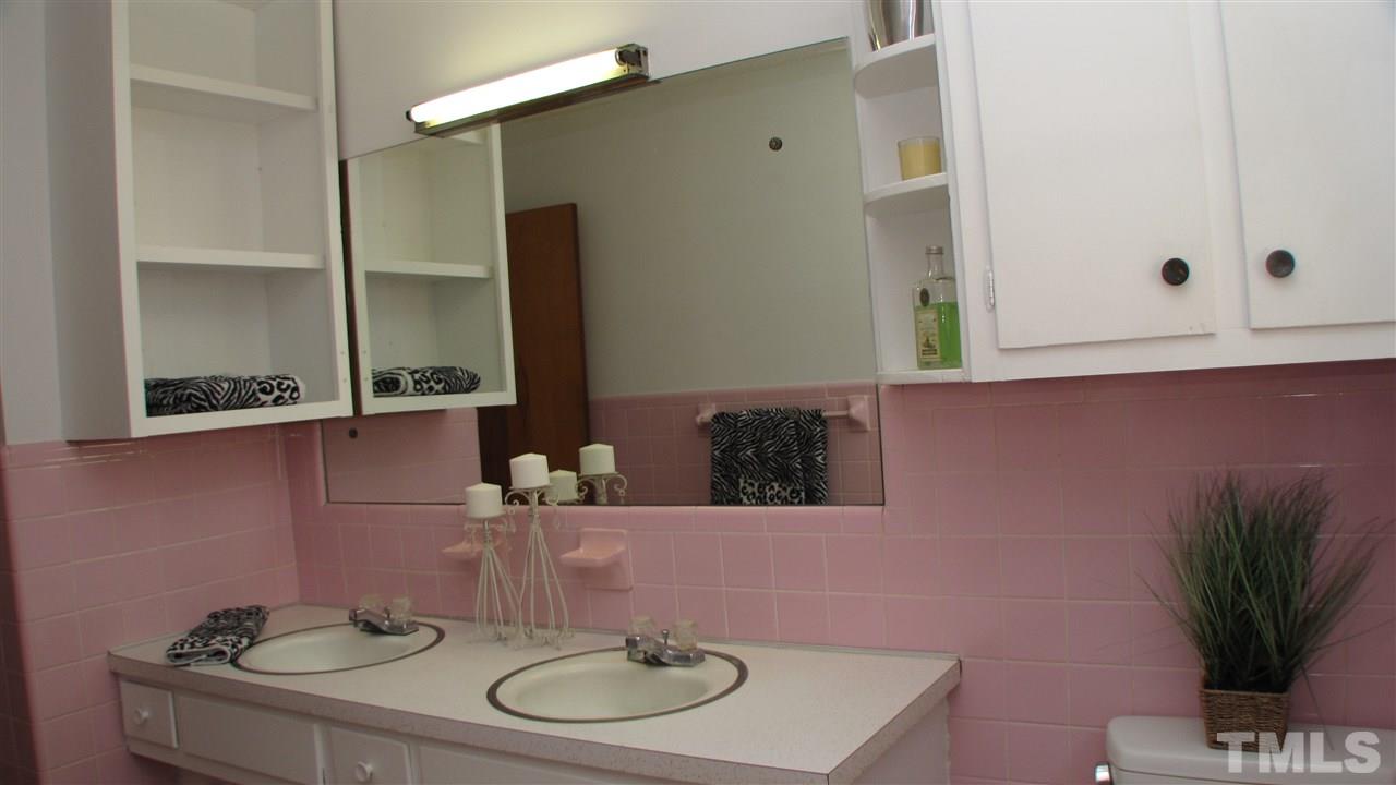 1210 Hamlin Road Durham, NC 27704 - Photo 12 of 18 The Full Bath has ample storage and dual sinks.