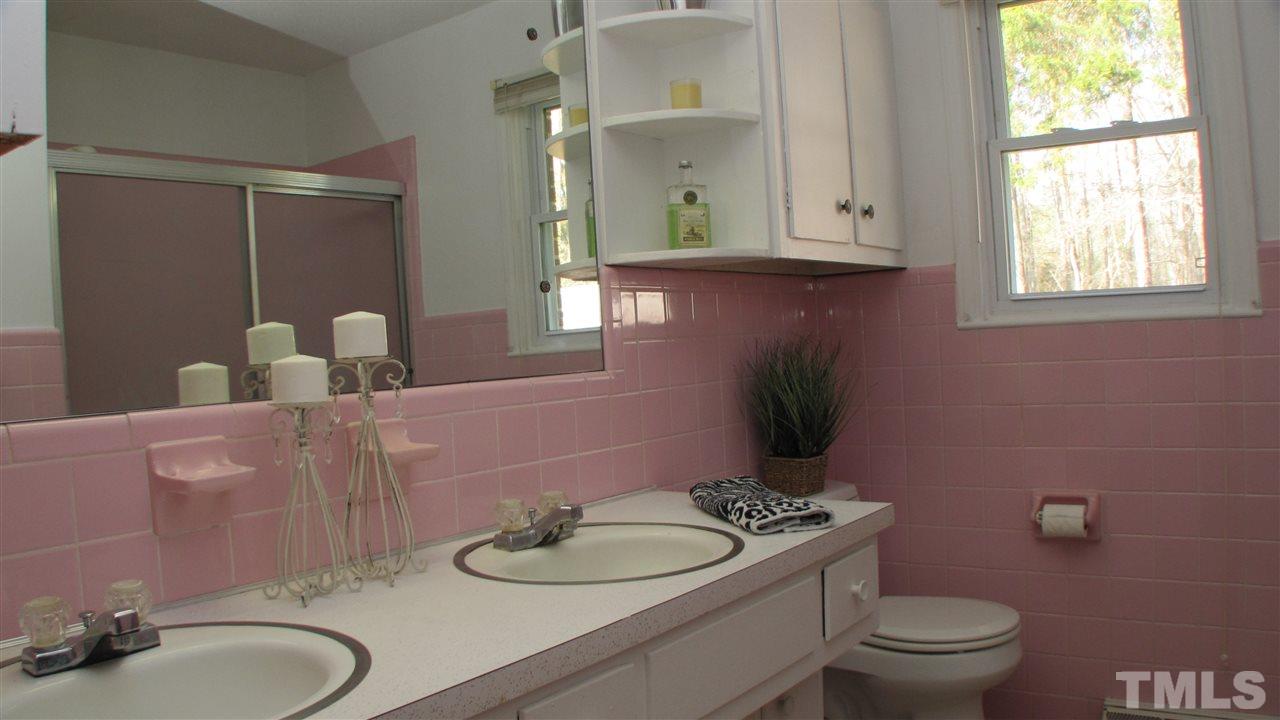1210 Hamlin Road Durham, NC 27704 - Photo 13 of 18 The Bathroom has a Tile surround.