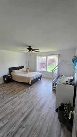 a bedroom with furniture and a wooden floor