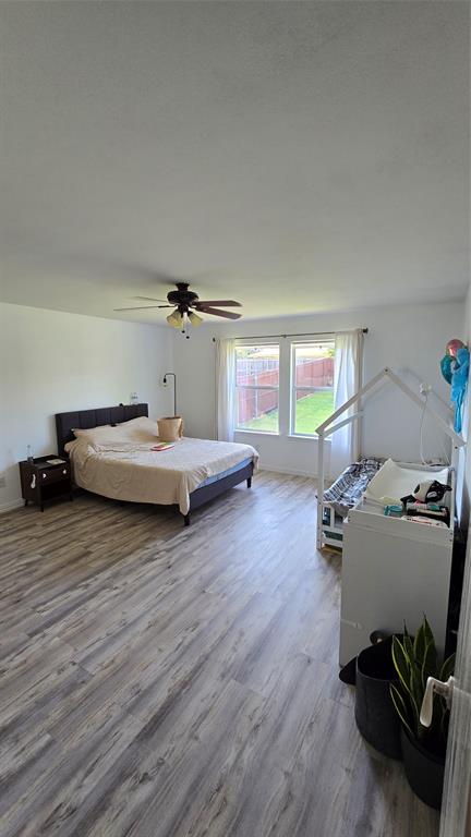 9520 George Washington Drive McKinney, TX 75072 - Photo 3 of 13 a bedroom with furniture and a wooden floor