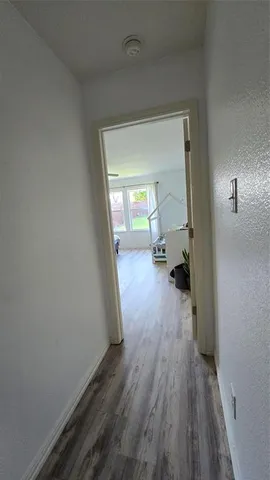 a view of a room with wooden floor a sink and a window