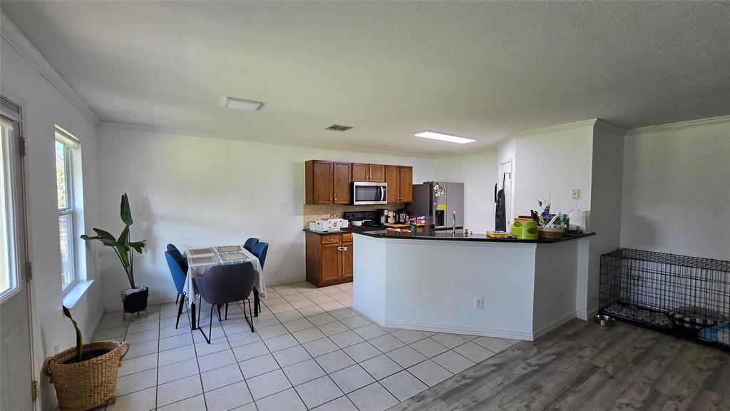 9520 George Washington Drive McKinney, TX 75072 - Photo 8 of 13 a living room with furniture a dining table and kitchen view