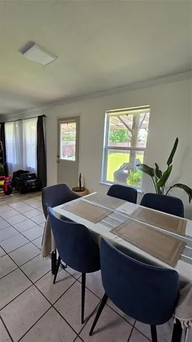 a view of a dining room with furniture and window