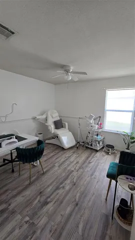 a living room with furniture a window and a wooden floor