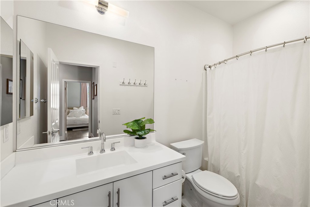 2 Agrios Street Rancho Mission Viejo, CA 92694 - Photo 13 of 29 a bathroom with a sink a toilet a mirror and vanity