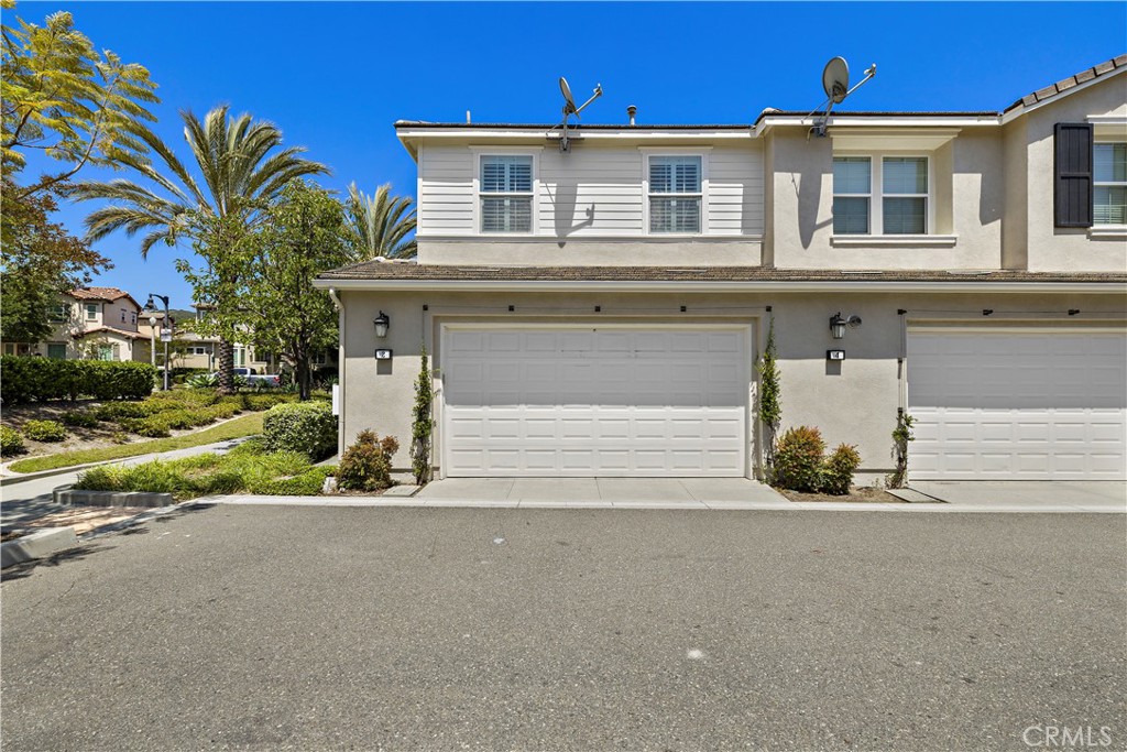 2 Agrios Street Rancho Mission Viejo, CA 92694 - Photo 19 of 29 a front view of a house with a yard and garage