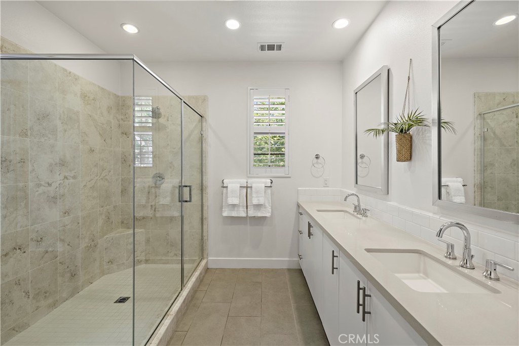 2 Agrios Street Rancho Mission Viejo, CA 92694 - Photo 4 of 29 a spacious bathroom with a double vanity sink a mirror and a shower