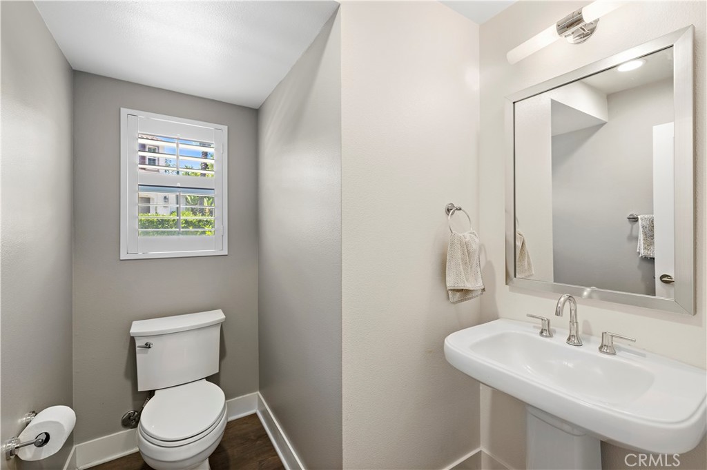 2 Agrios Street Rancho Mission Viejo, CA 92694 - Photo 9 of 29 a bathroom with a toilet a sink and mirror