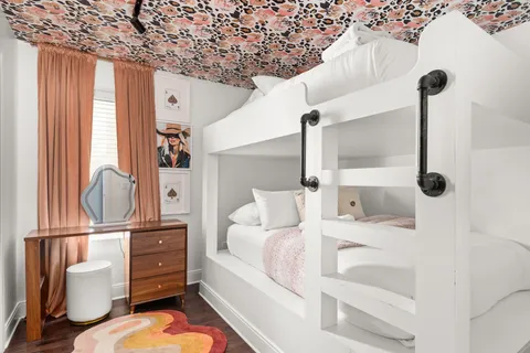 a view of a room that has a door and a painting on the wall