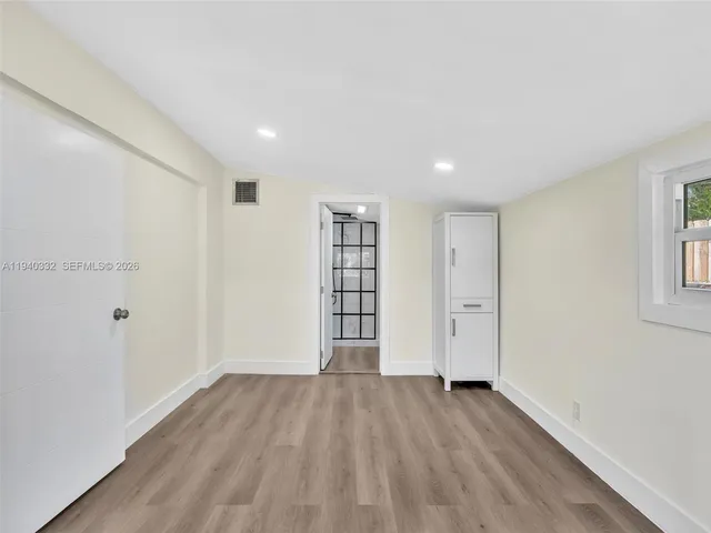 a view of wooden floor and windows in a room