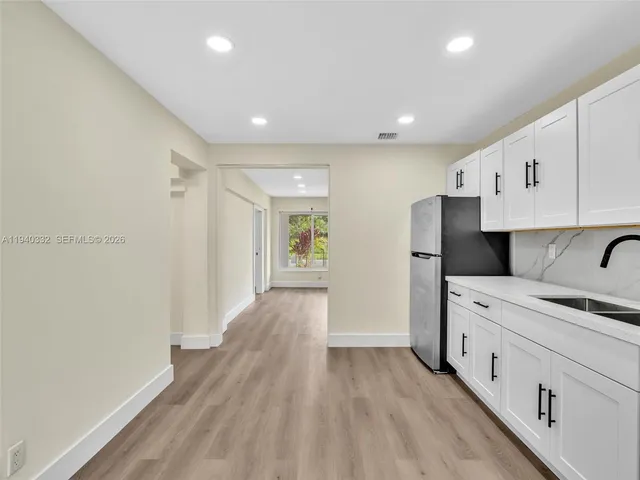 a view of a kitchen with electric appliances