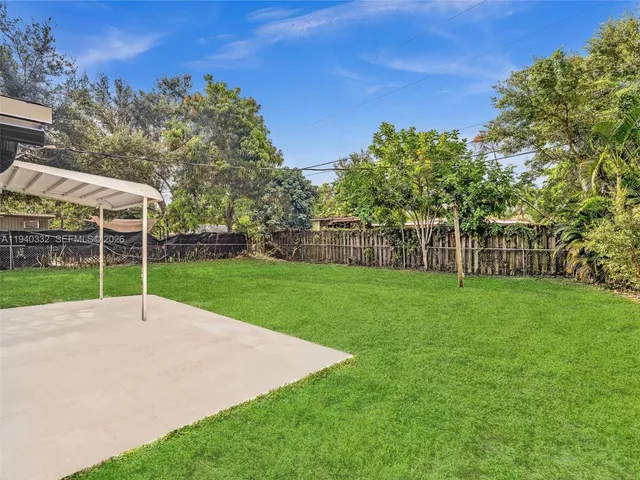 a view of a park with large trees and a big yard