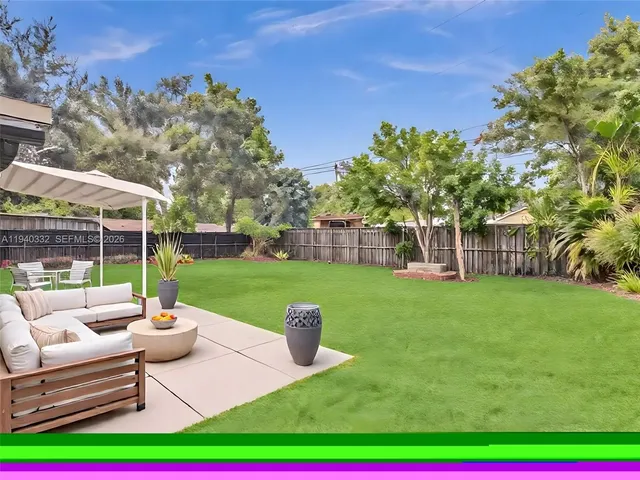 a view of a patio with couches chairs and a yard