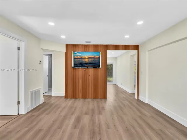 a view of hallway with wooden floor