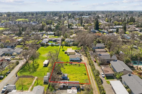 an aerial view of residential houses with outdoor space