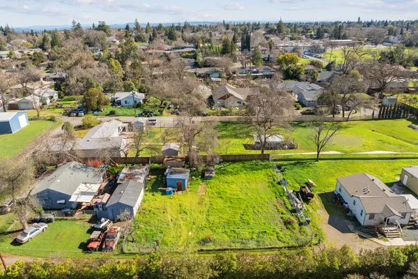 an aerial view of residential houses with outdoor space and swimming pool
