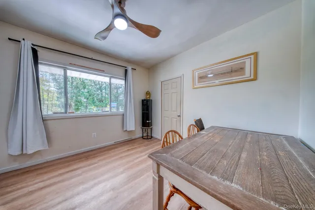 a workspace with wooden floor and a large window