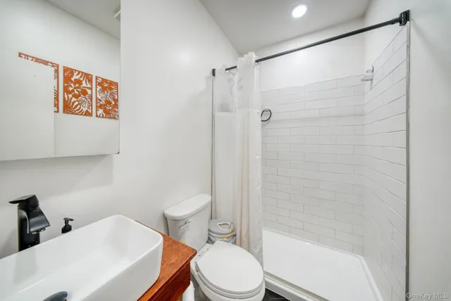 a white toilet sitting next to a bathroom sink