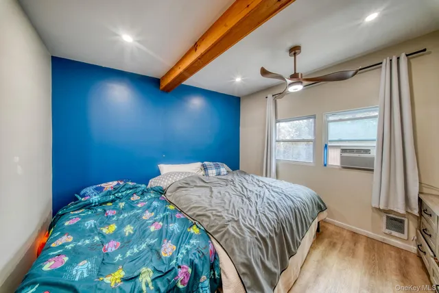 a bedroom with a bed and a window