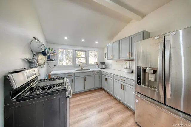a kitchen with stainless steel appliances granite countertop a stove and a refrigerator