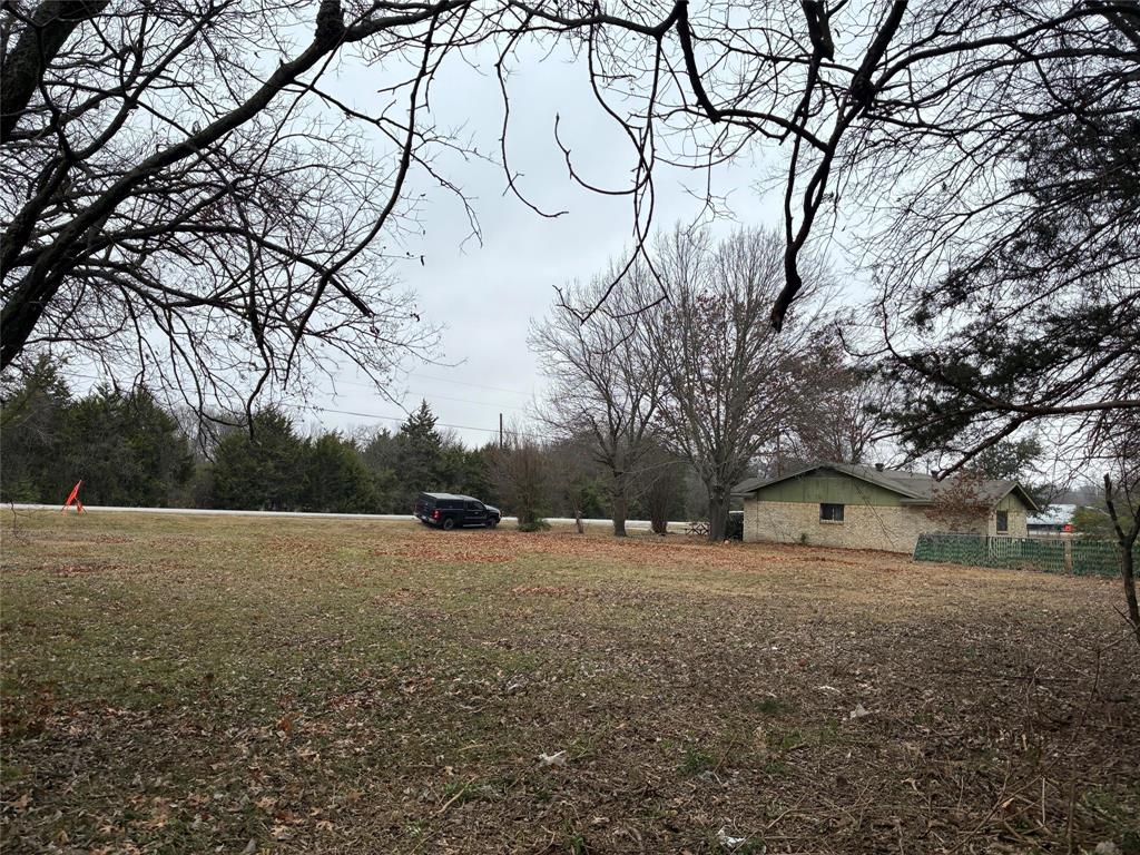 1118 North Lancaster Hutchins Road Lancaster, TX 75146 - Photo 2 of 3 a view of yard with tree and wooden fence