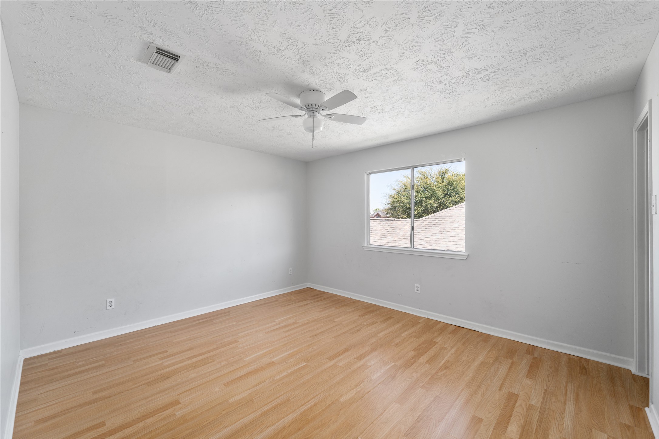 11959 Swords Creek Road Houston, TX 77067 - Photo 18 of 30 wooden floor in an empty room with a window