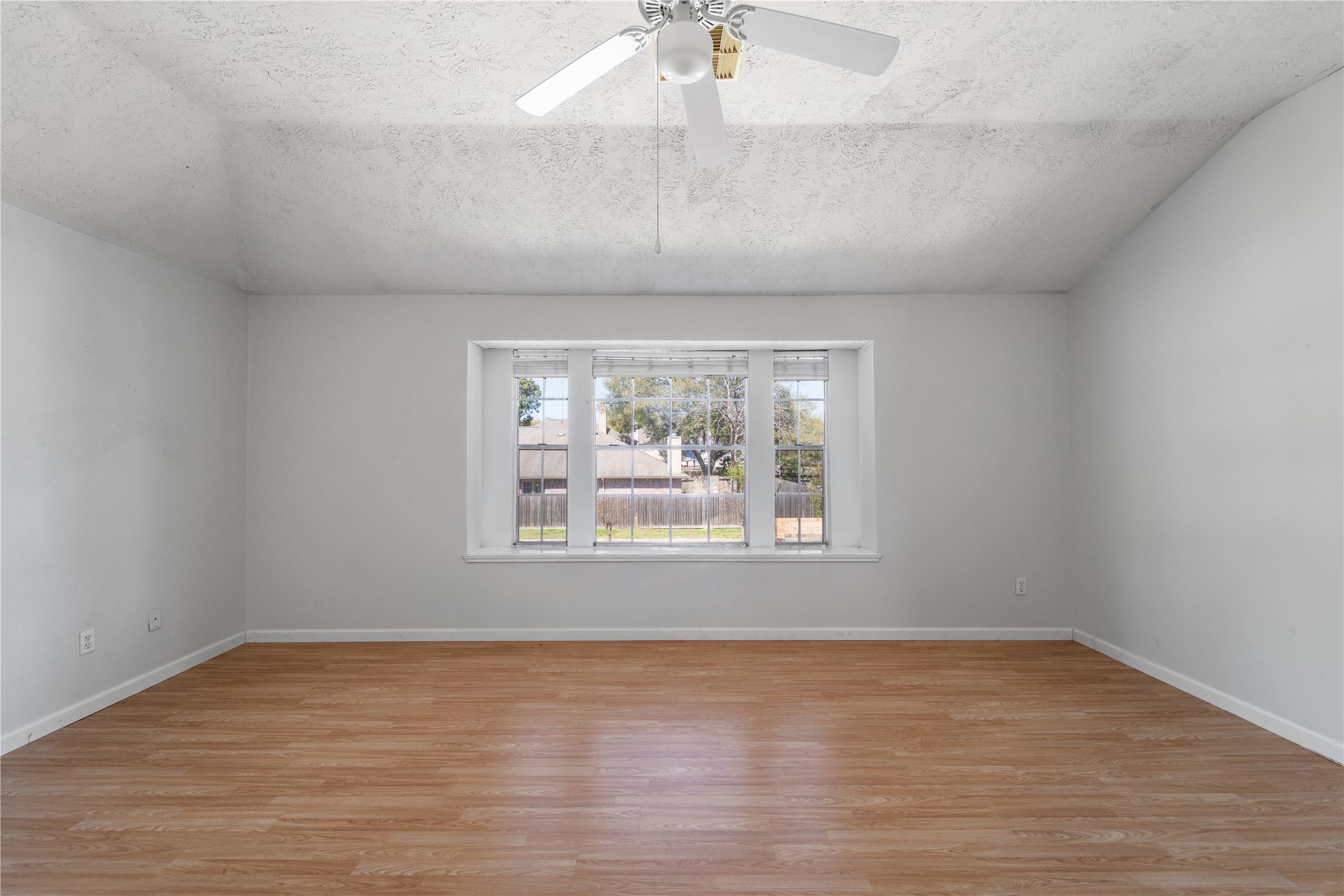 11959 Swords Creek Road Houston, TX 77067 - Photo 23 of 30 an empty room with wooden floor and windows
