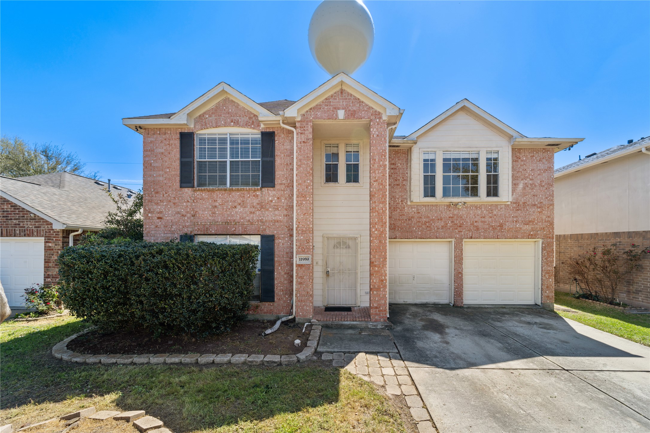 11959 Swords Creek Road Houston, TX 77067 - Photo 4 of 30 a front view of a house with a yard and garage