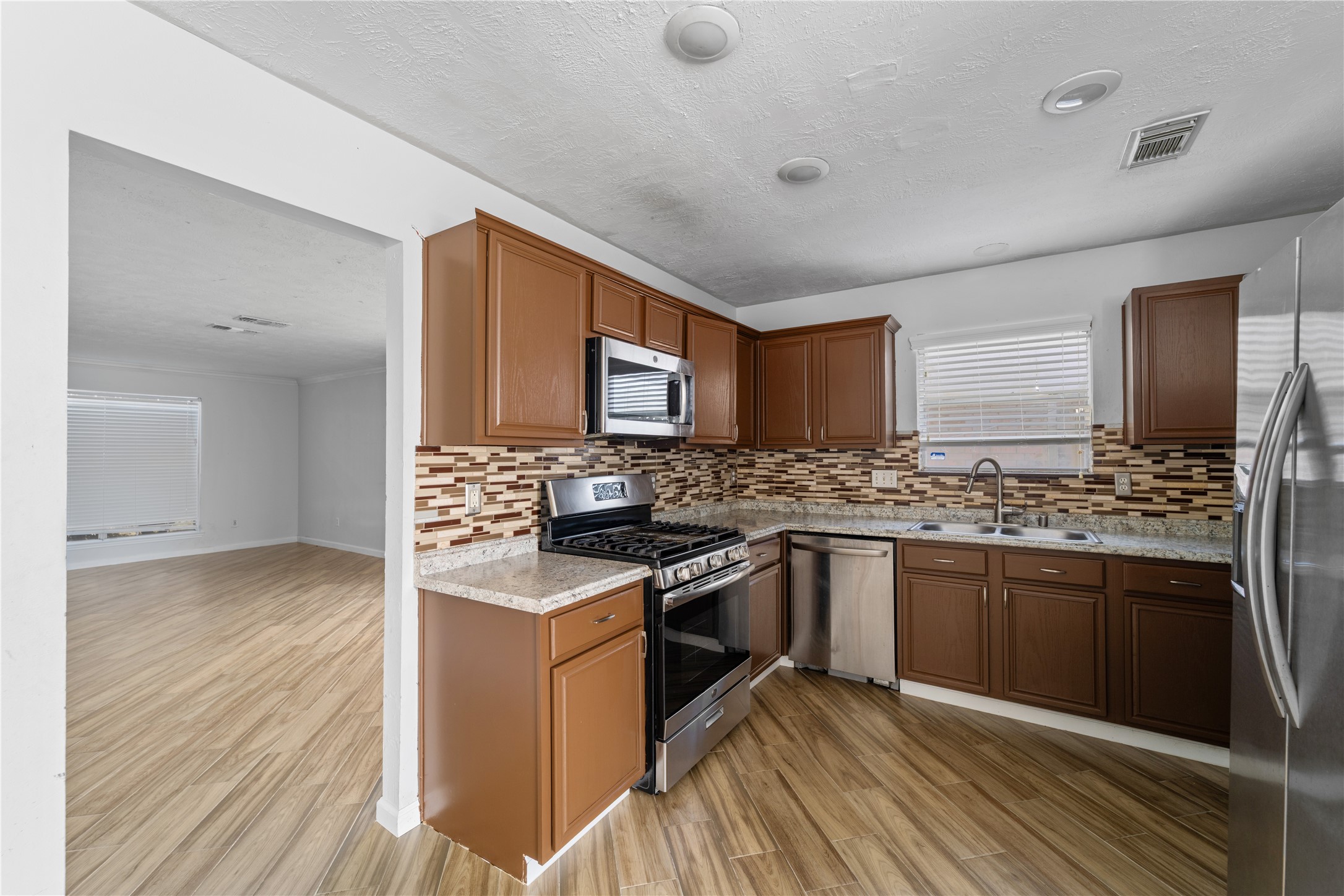 11959 Swords Creek Road Houston, TX 77067 - Photo 10 of 30 a kitchen with stainless steel appliances granite countertop a stove and a sink