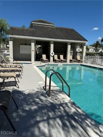 a view of a house with pool porch and chairs