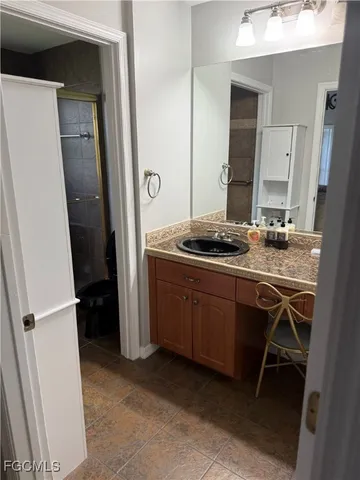 a bathroom with a glass shower door