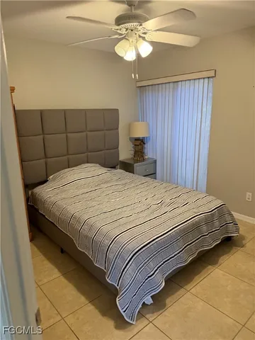 a bedroom with a bed and a chair
