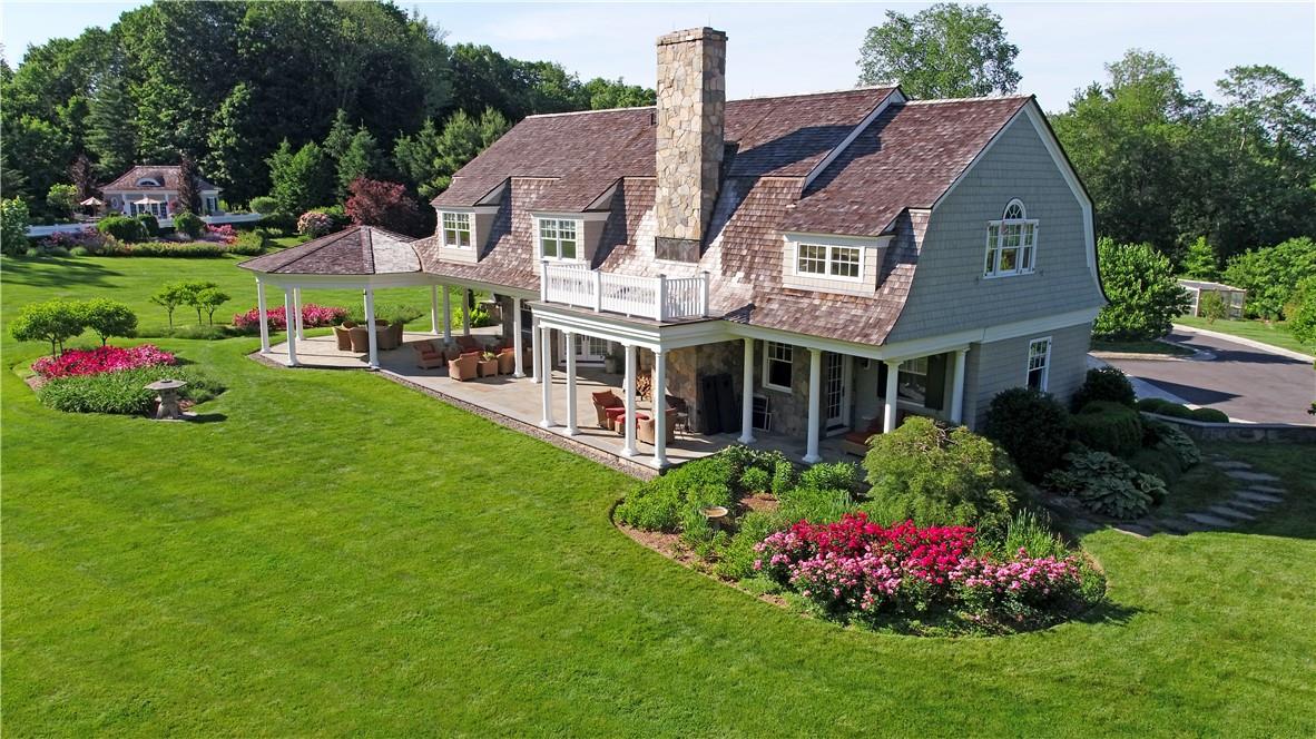 a view of a house with a big yard and potted plants