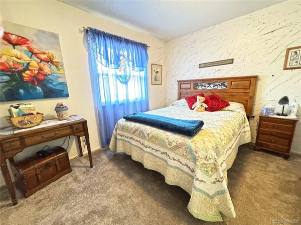 a view of a bedroom with closet and toys